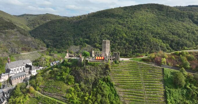 Rotating drone of Castle Metternich, Beilstein, Germany, with green mountains in the background