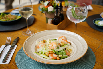 Shrimp Caesar salad with Parmesan and croutons