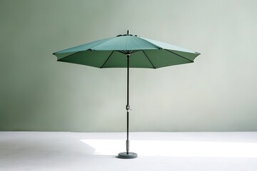 Fototapeta premium Green umbrella on white floor against pastel wall
