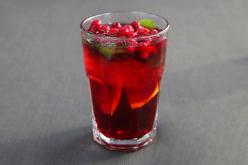 Berry cranberry tea with mint in a glass glass