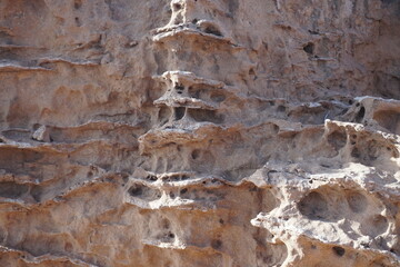 Amazing nature. Texture of the rock on the sea. Weathered and washed by water splashes. Stones on the shore.