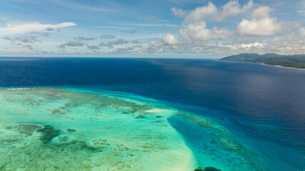 The coast of a tropical island covered with forest. Balabac, Palawan. Philippines.