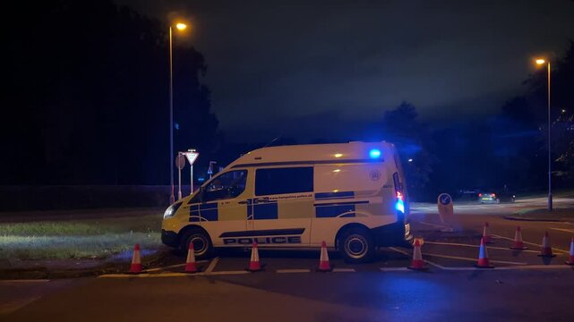 England police car with flashing lights blocked the road. Accident.