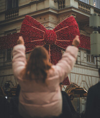 girl ties a huge christmas bow