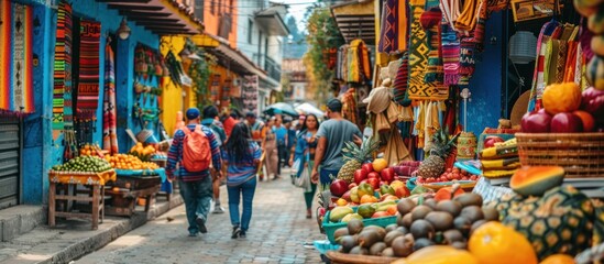 Obraz premium Vibrant marketplace street scene with colorful buildings, shoppers, and abundant fresh produce.
