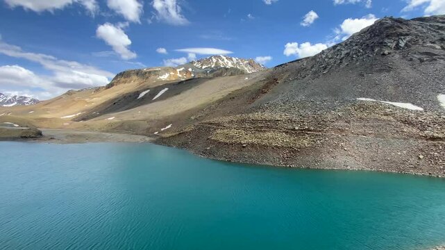 Suraj tal, also called tso kamtsi or surya tal in lahaul and spiti valley, beautiful high mountain range with melting snow and bright blue water in himachal pradesh, northern India.