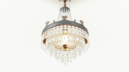 Obraz premium A classic crystal chandelier hangs from a white ceiling, its intricate design and glittering prisms casting a warm glow