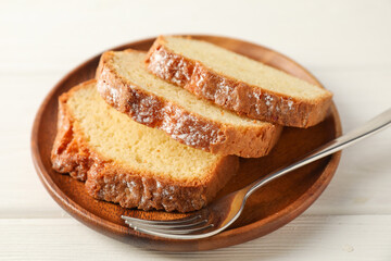 Freshly baked sponge cake on white wooden table, closeup