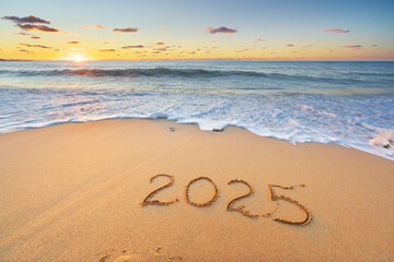 2025 text symbol on the sea sand beach.