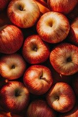 Fresh and Juicy Red Apples Piled Together in a Bright Orange Basket, Showcasing Their Crisp Texture and Vibrant Color in Natural Lighting