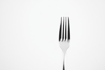 A single, stainless steel fork against a white background.