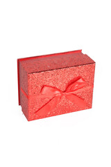 A red gift box with a ribbon, isolated on a white background, emphasizing its festive and elegant appearance