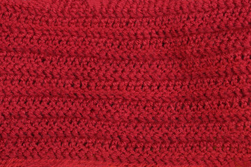 A close-up of a knitted wool texture in a rich burgundy color, perfect for a cozy and warm background