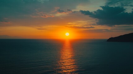 Fototapeta premium Andaman Sunset: Golden Hour over the Sea - Breathtaking sunset over the Andaman Sea, showcasing vibrant colors, tranquil waters, and a silhouette of land. Peace, serenity, nature, beauty, escape.