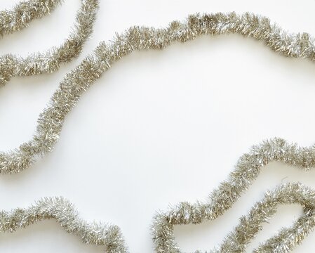 Overhead view of Silver tinsel on a white background