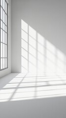 Fototapeta premium Minimalist white interior with dramatic window light casting geometric shadows on empty floor and wall, creating striking pattern of light and shadow in clean space.