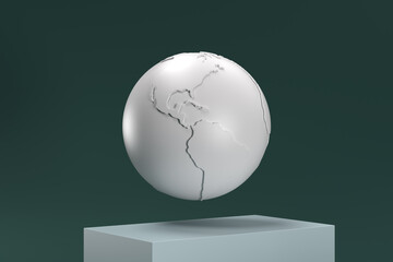 A white globe is suspended in midair on a pedestal