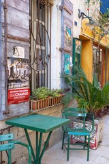 Cozy street café with green table and chairs in charming old town