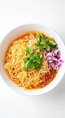 Spicy Asian noodle soup served in white ceramic bowl with fresh cilantro, shredded purple cabbage, and chili oil floating on top, photographed from above on light background.