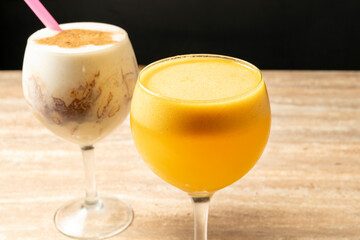 Two delicious beverages, a vibrant passion fruit juice and a creamy milkshake, presented in elegant glasses, ready to be enjoyed
