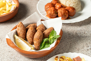 Traditional lebanese kibbeh served with fresh mint and lemon, showcasing the rich flavors of middle eastern cuisine