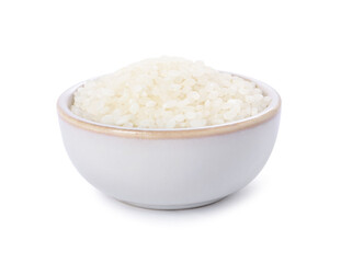 Raw rice in bowl isolated on white