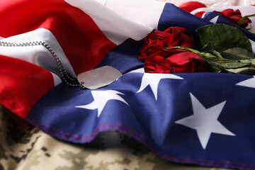 Veterans day. Army token, American flag, roses and military uniform, closeup