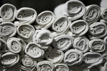 Stacked white towels neatly arranged in a bathroom setting