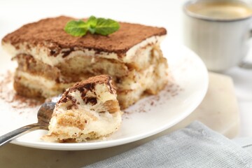 Piece of tasty tiramisu on table, closeup