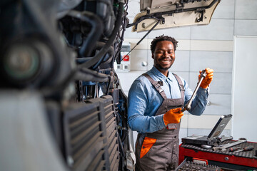 Experienced mechanic working on truck repair.