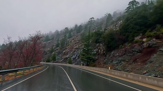 Driving Point of view action cam through Troodos mountains in Cyprus foggy and wet conditions mediterranean