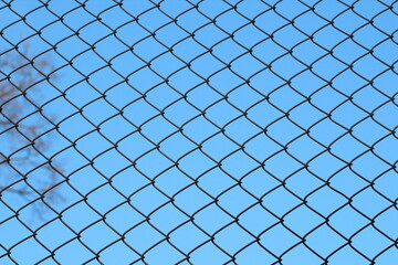 Metal fence texture with blue sky background 