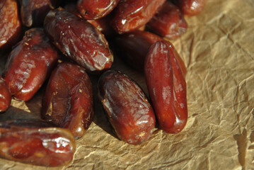dried dates on craft paper close-up. selective focus