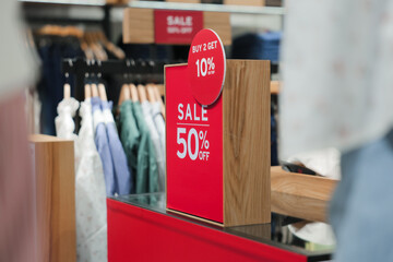 Signs announcing the start of sales in the store, sale signs in front of the store, discounts up to 50 percent, ideas for buying products during the end of the year sale