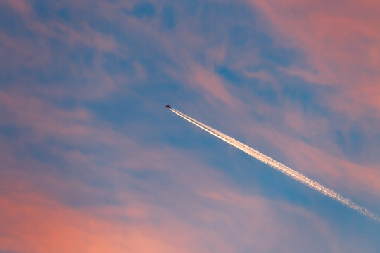 Airplane in the evening sky - Powered by Adobe