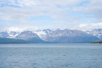 Snowy mountains, fjord and blue sky in Norwegian landscape in Olderdalen, Norway