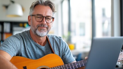 A senior man fully absorbed in his guitar playing, sits by a laptop at home, embodying concentration, passion for music, and the joy of artistic creation.