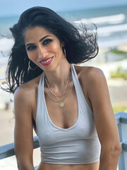 Ethnic woman wearing a halter top enjoying beach views