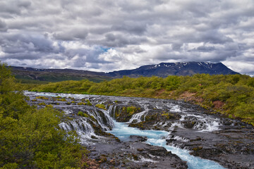 Bruarfoss or Bridge Falls, small hidden waterfall blue striking color, Iceland’s Bluest Waterfall, along Bruara river. Golden Circle South Iceland