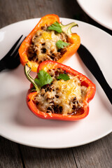 Stuffed peppers with herbs and cheese on the rustic background. Selective focus. Shallow depth of field.