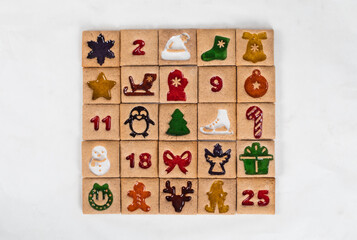 Christmas Advent Calendar. 25 Ginger square cookies with colored themed marmalade filling in the shape of an Advent Calendar.  White background. Top view
