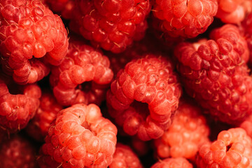Ripe and juicy raspberry on the dark rustic background. Shot from above.
