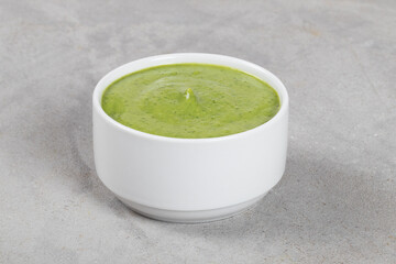 Vegan Pea mint cream soup. In a bowl. Light background. Close up