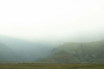 Icelandic mountains shrouded in clouds, creating a mystical atmosphere