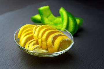 vibrant essence of lemon slices juxtaposed with the earthy tones of dried pomelo, creating a striking contrast against a dark backdrop that highlights their textures and colors