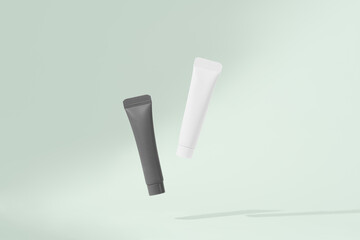 White and black mockup of tubes levitating on green isolated background with drop shadow. The concept of natural care cosmetics for the skin of the face, presentation of beauty products
