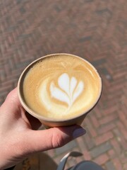 Coffee to go with a milk foam flower