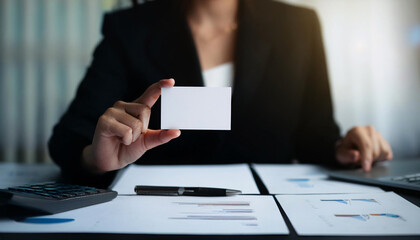 Business card mock up on a desk with financial documents and a calculator showcasing professional accounting setup