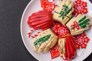 Naklejka premium Sweet Madeleines desserts covered with chocolate in Christmas colors