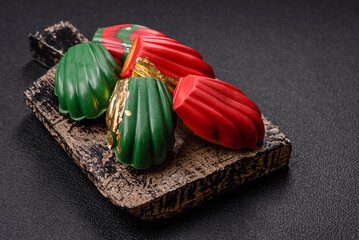 Fototapeta premium Sweet Madeleines desserts covered with chocolate in Christmas colors